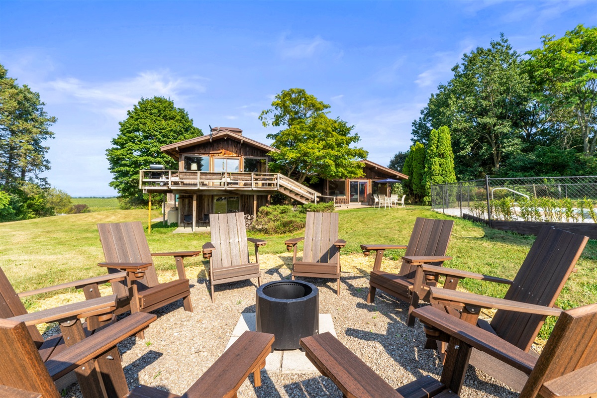 Cozy fire pit with Adirondack seating, perfect for relaxing evenings and gatherings under the stars.