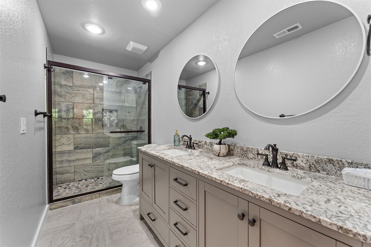 Refresh and unwind in the spacious primary bathroom with a walk-in shower and double vanity.
