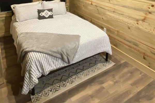 Upstairs: queen bed, smart TV, box fan, privacy shades, and child safety gate