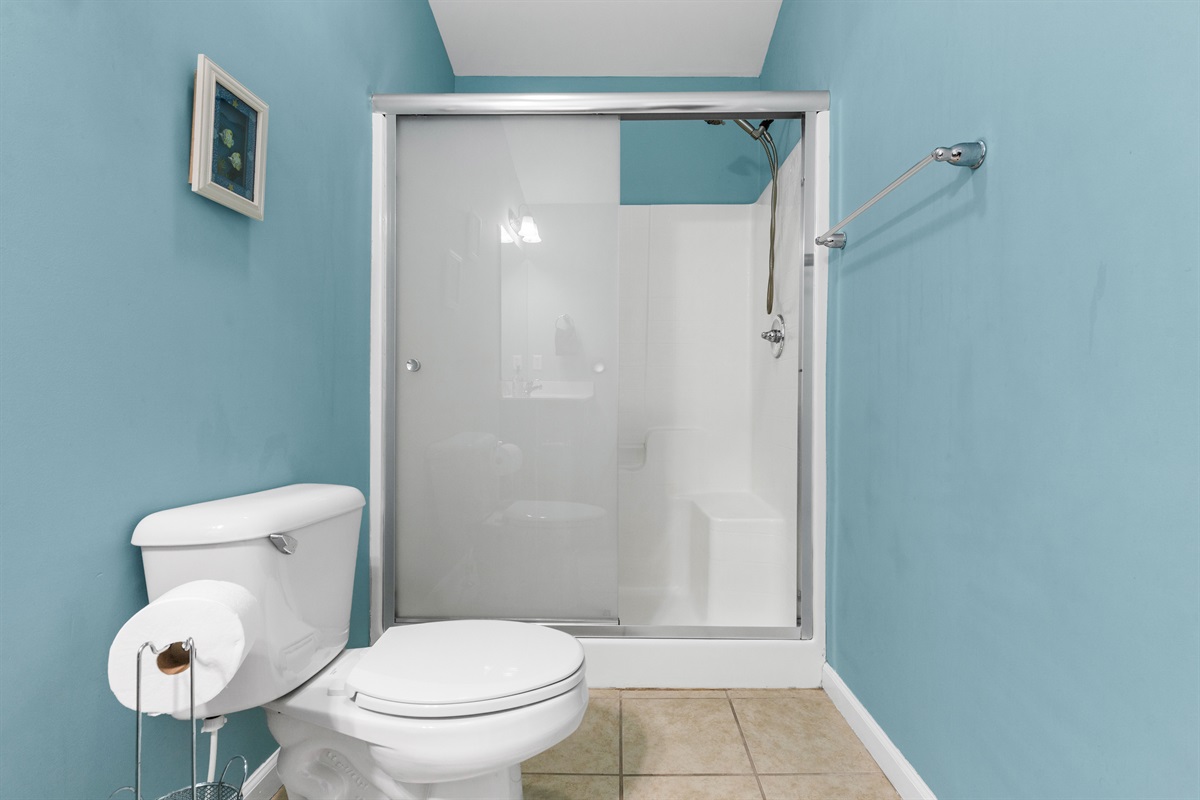 Walk-in shower with sliding glass doors for a clean, modern feel