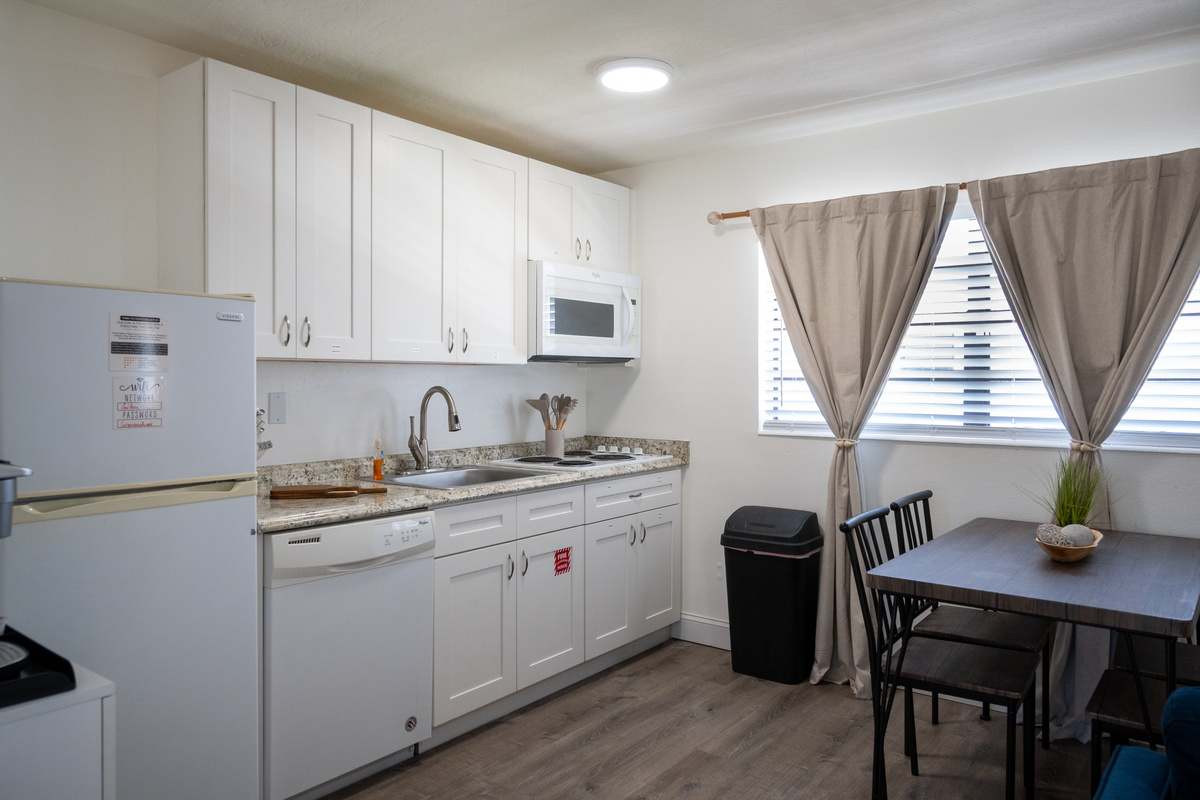 Full kitchen with dishwasher, full-size fridge and dining for four