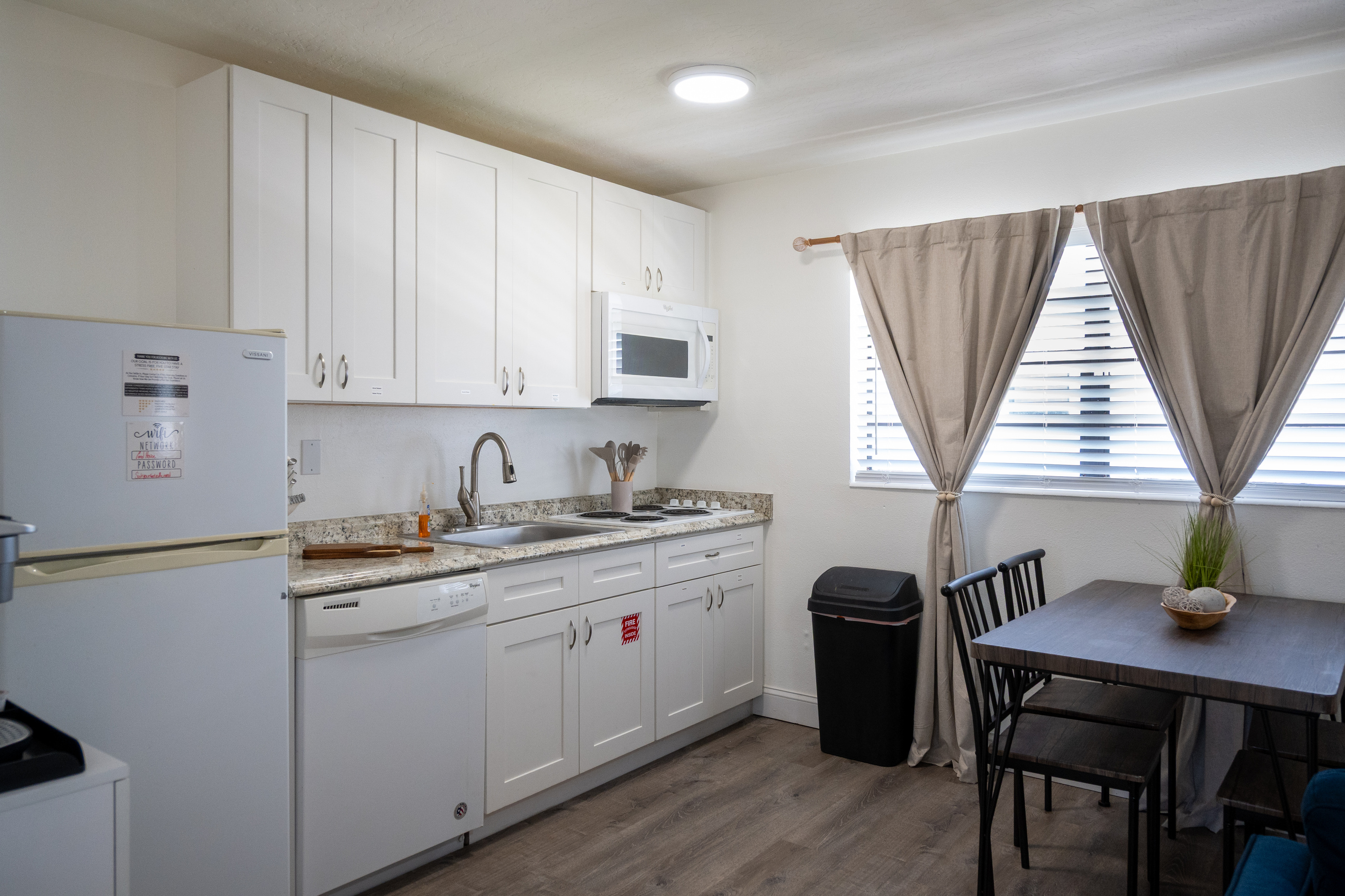 Full kitchen with dishwasher, full-size fridge and dining for four