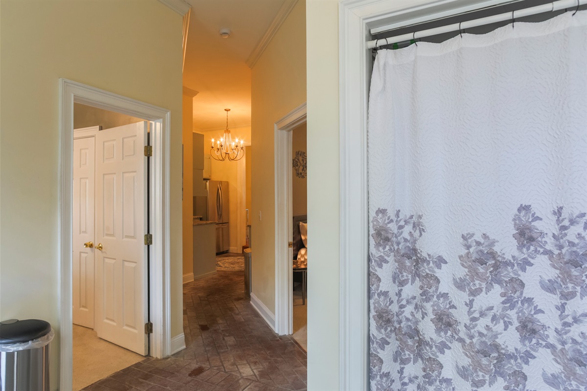 Washer and dryer tucked neatly behind a curtain for easy use during your stay.