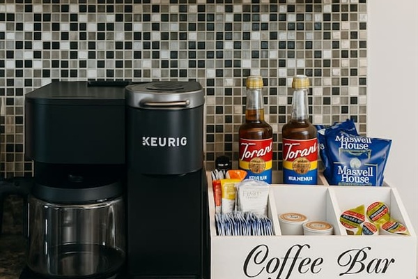 Coffee bar with drip and pod coffee. Starter set of coffee grounds, coffee pods, sugar, creamer and syrups provided.