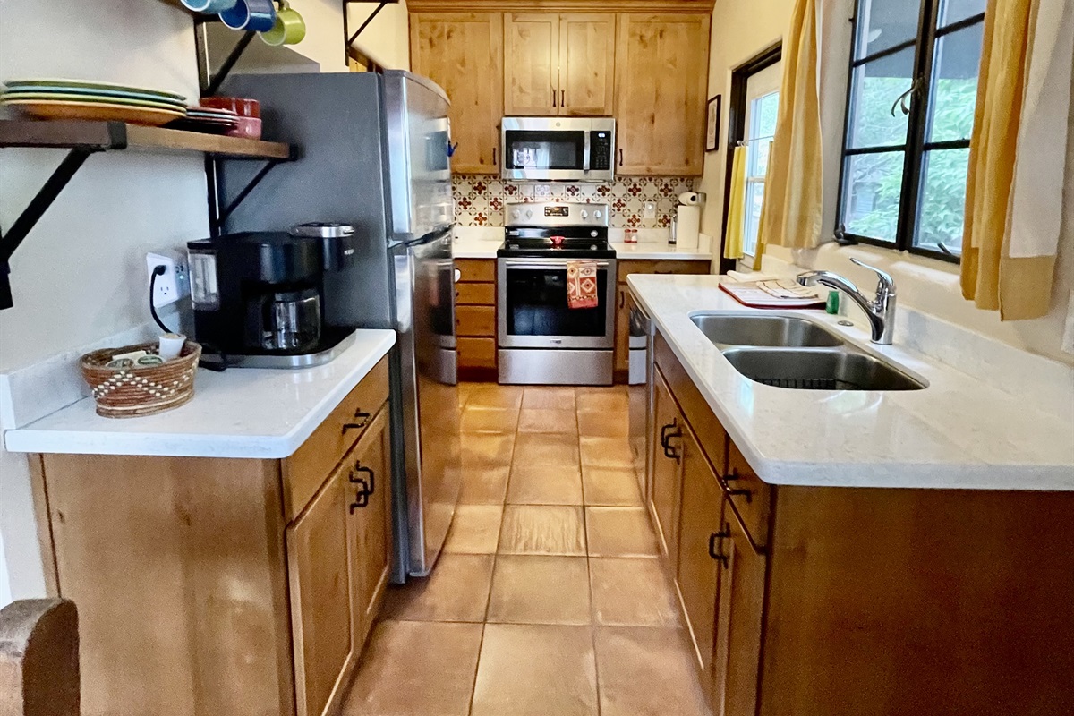 Cooking is a breeze in this fully equipped kitchen, featuring modern appliances and ample counter space.