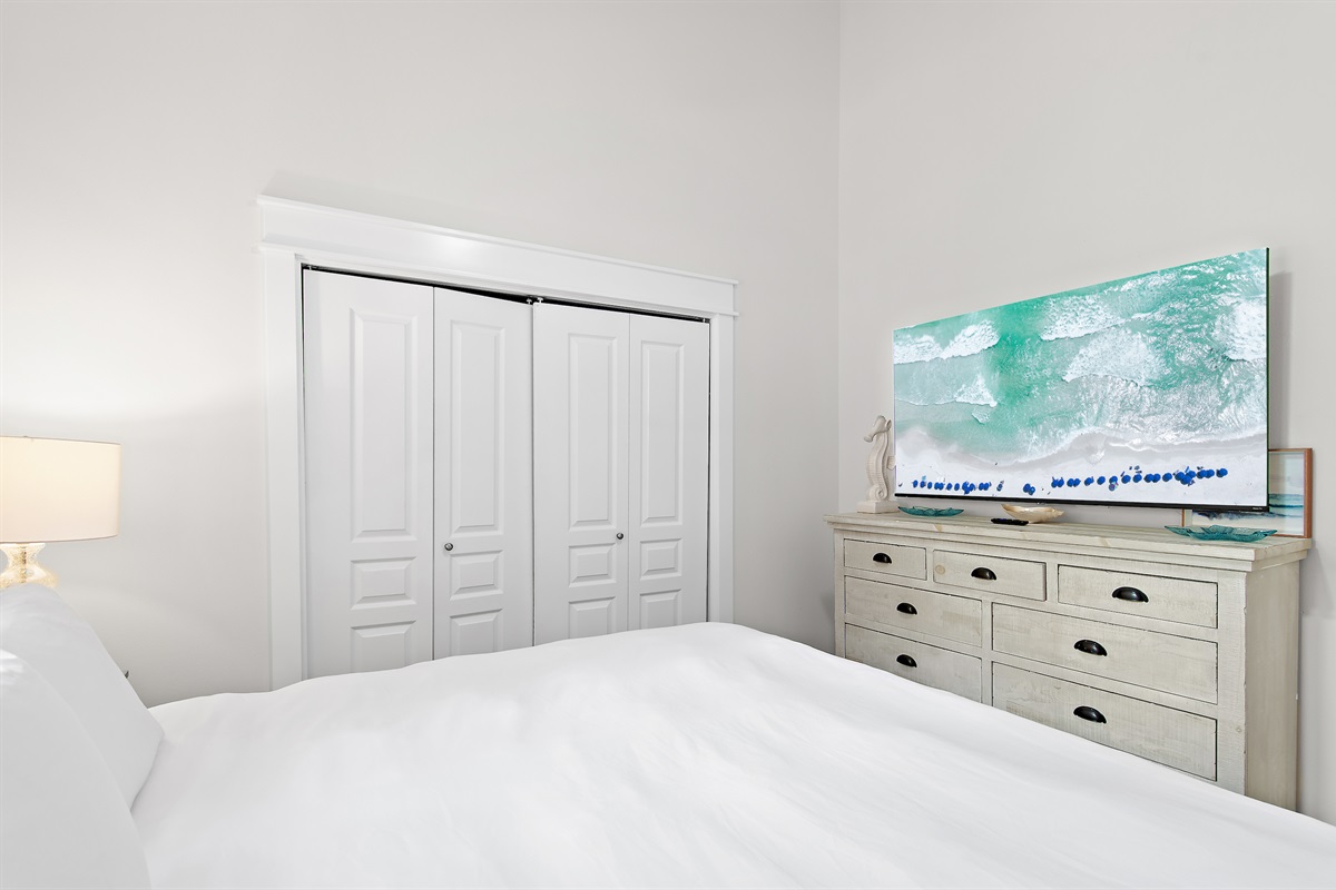 Bright bedroom with ample storage and TV