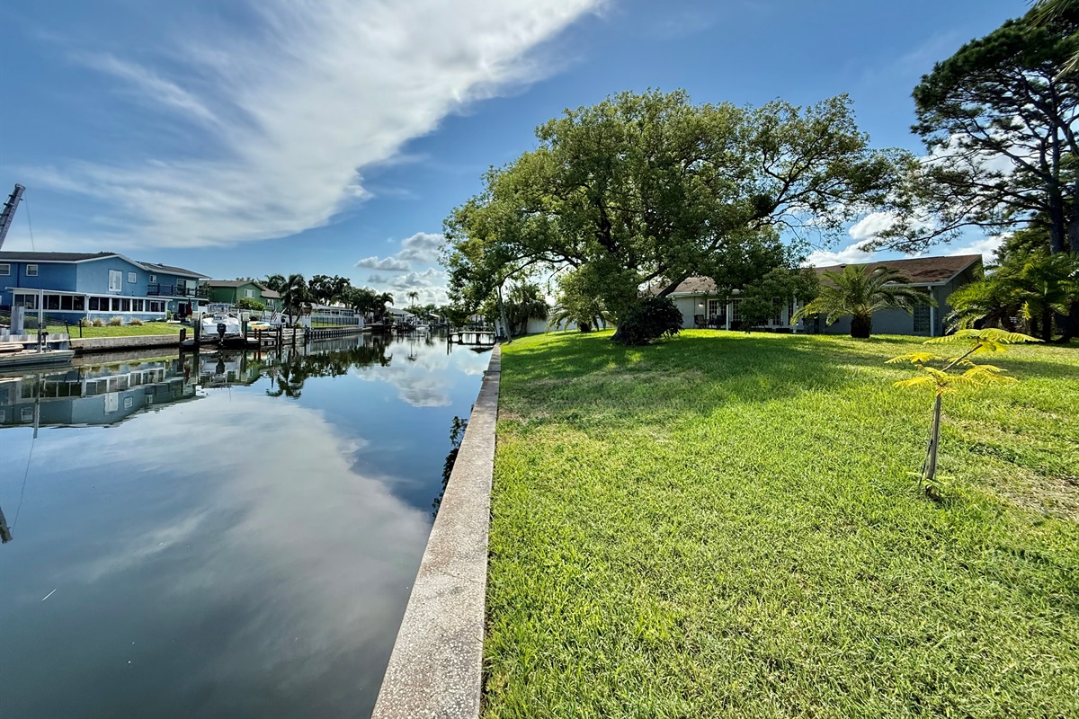 This backyard delivers postcard-worthy views with calm waters, lush grass, and a tranquil atmosphere that invites you to relax and recharge.