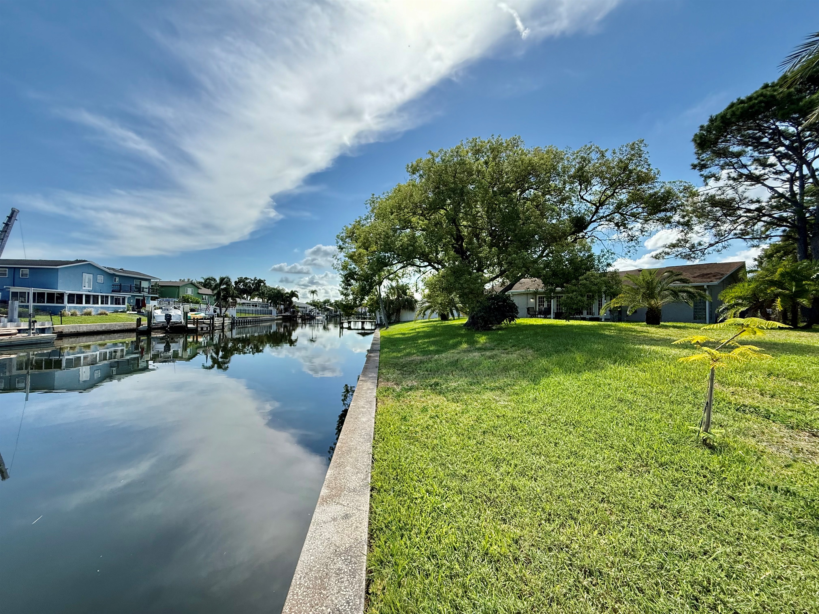 This backyard delivers postcard-worthy views with calm waters, lush grass, and a tranquil atmosphere that invites you to relax and recharge.