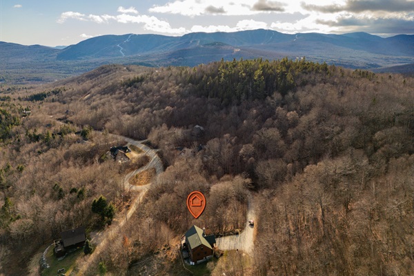 This aerial view reveals the beauty of the home nestled in nature’s embrace.