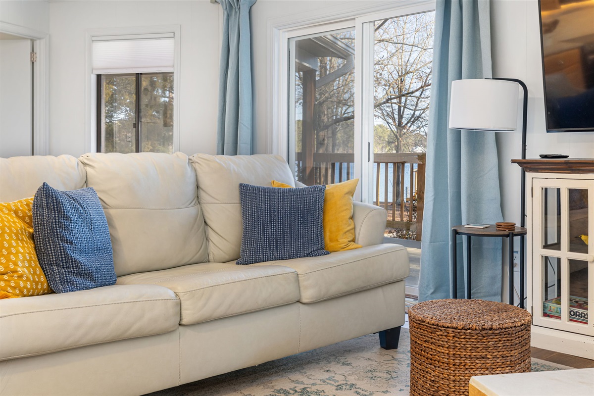 Living Room Retreat: Bright open space with lake views, inviting decor, and plush seating awaits!