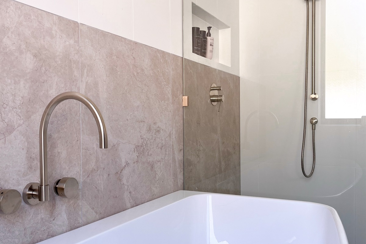This bathroom angle shows the shower area, wall niche and neutral tiles, adding another useful view of the home’s bathroom setup.