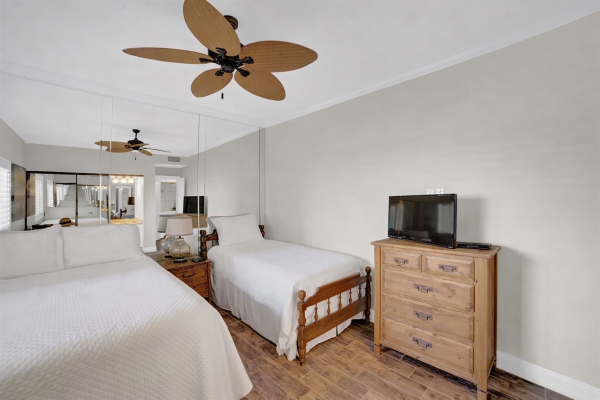 Guest bedroom will accommodate 3 guests. I will be removing the mirror wall, putting a new fan with light kit in, wall mounting a smart tv and a vanity.  