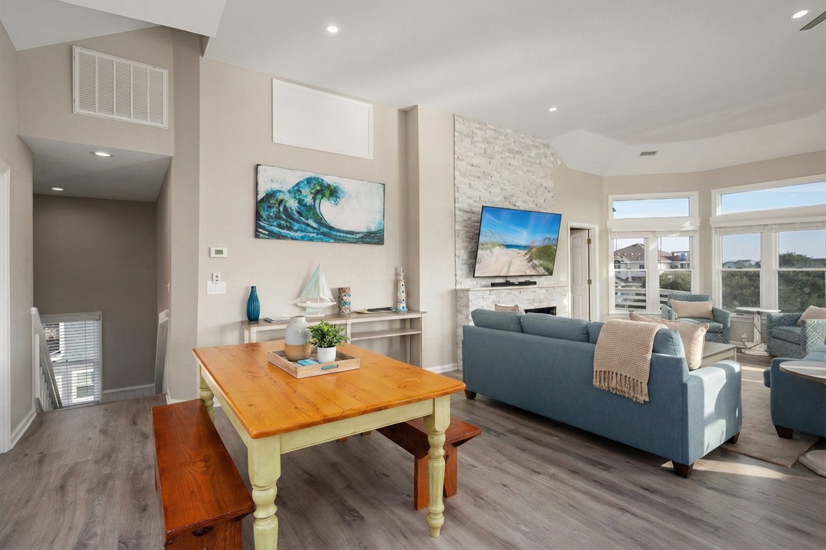 Modern living and entertainment space with a fireplace and stylish seating.