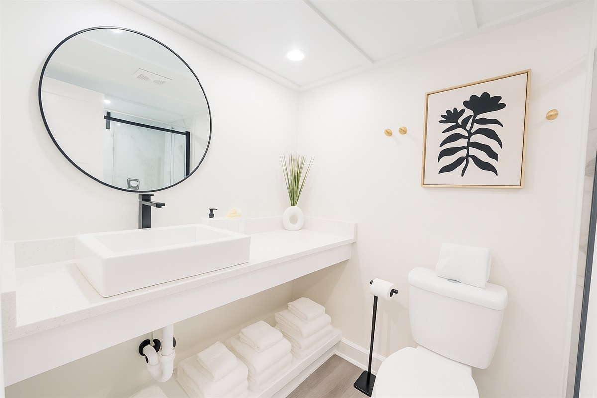 Clean crisp bathroom with walk in shower. 