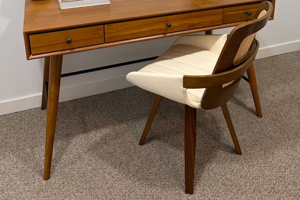 Dedicated workspace with a spacious wooden desk, a comfortable chair, and a quiet, calming setup for remote work.