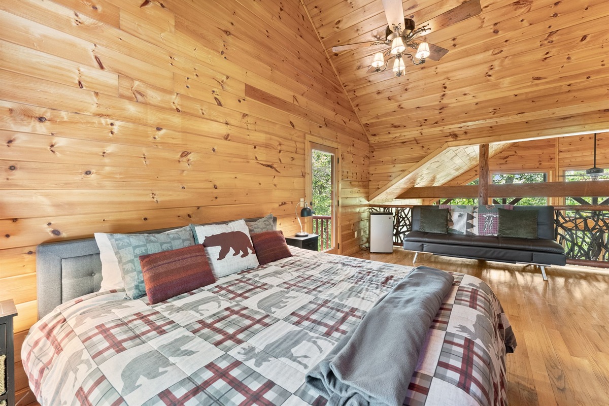 Open upstairs loft featuring a cozy king bed and full sleeper sofa &mdash; perfect for extra guests or a relaxing private retreat.