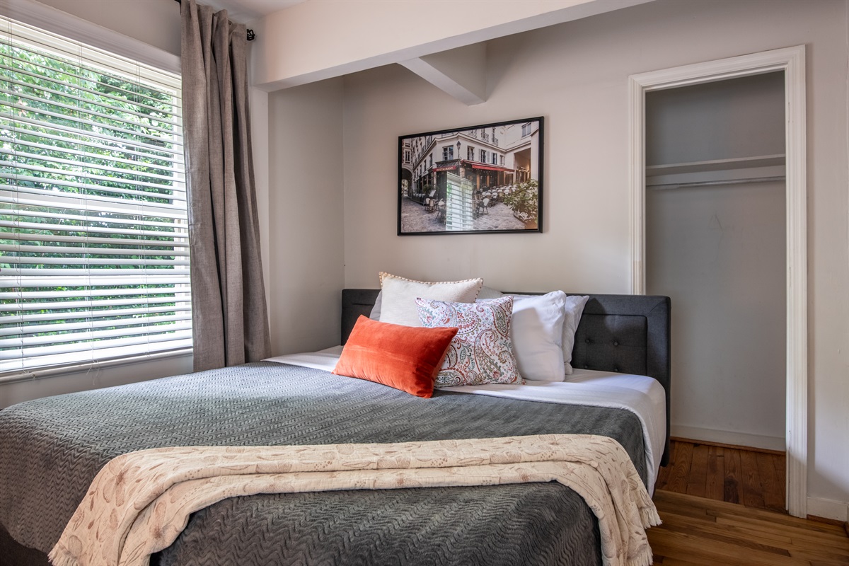 Spacious bedroom with elegant decor and cozy linens for a restful night's sleep.