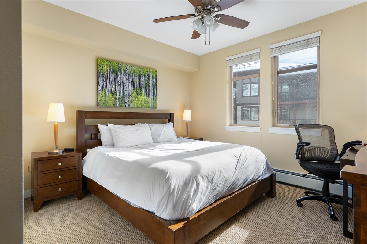 2nd bedroom ceiling fan, has windows overlooking the 3rd floor amenity deck/hot tub