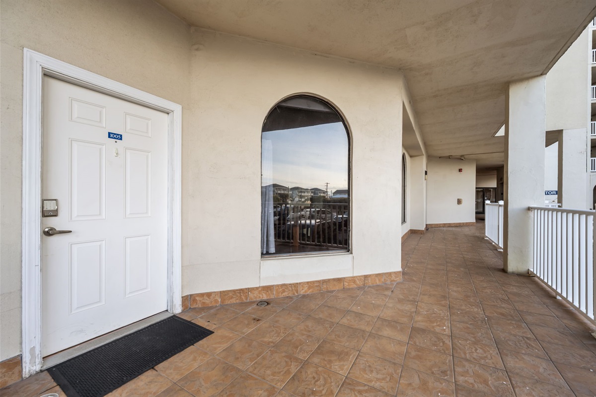 Ground level entry with wide walkway and nearby elevator
