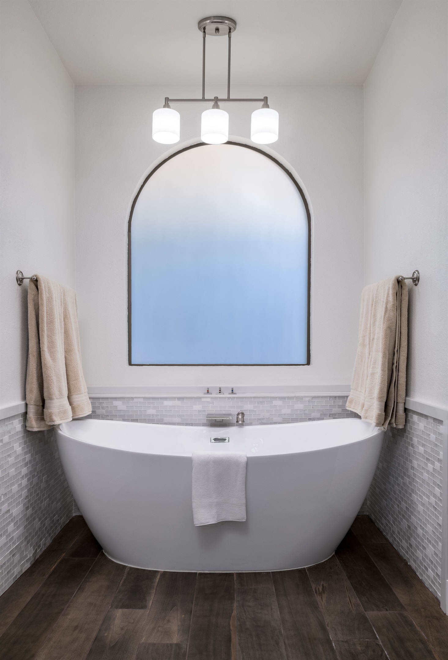 Treat yourself to spa-like luxury with a freestanding soaking tub, double vanities, and a serene modern design made for relaxation.