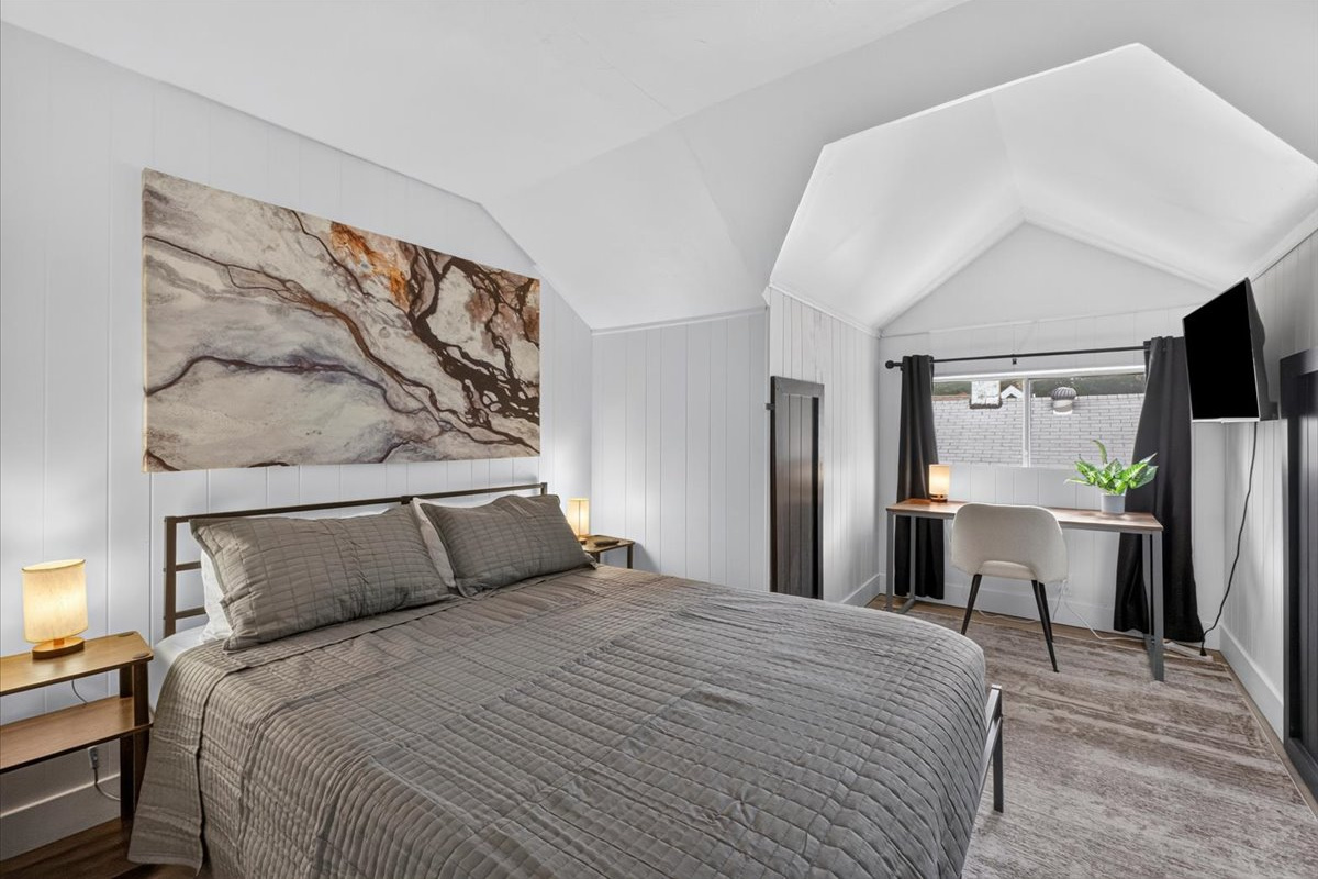 Second bedroom with a king bed and a dedicated workspace.
