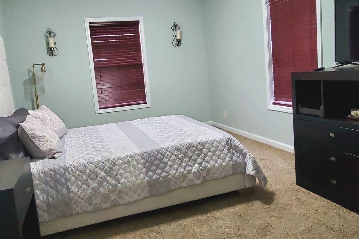 Split floorplan with Master suite on the main level. Tastefully decorated master bedroom with private TV, Roku for all of your streaming pleasures and walk in closet. Master bedroom includes secluded in suite bathroom. 