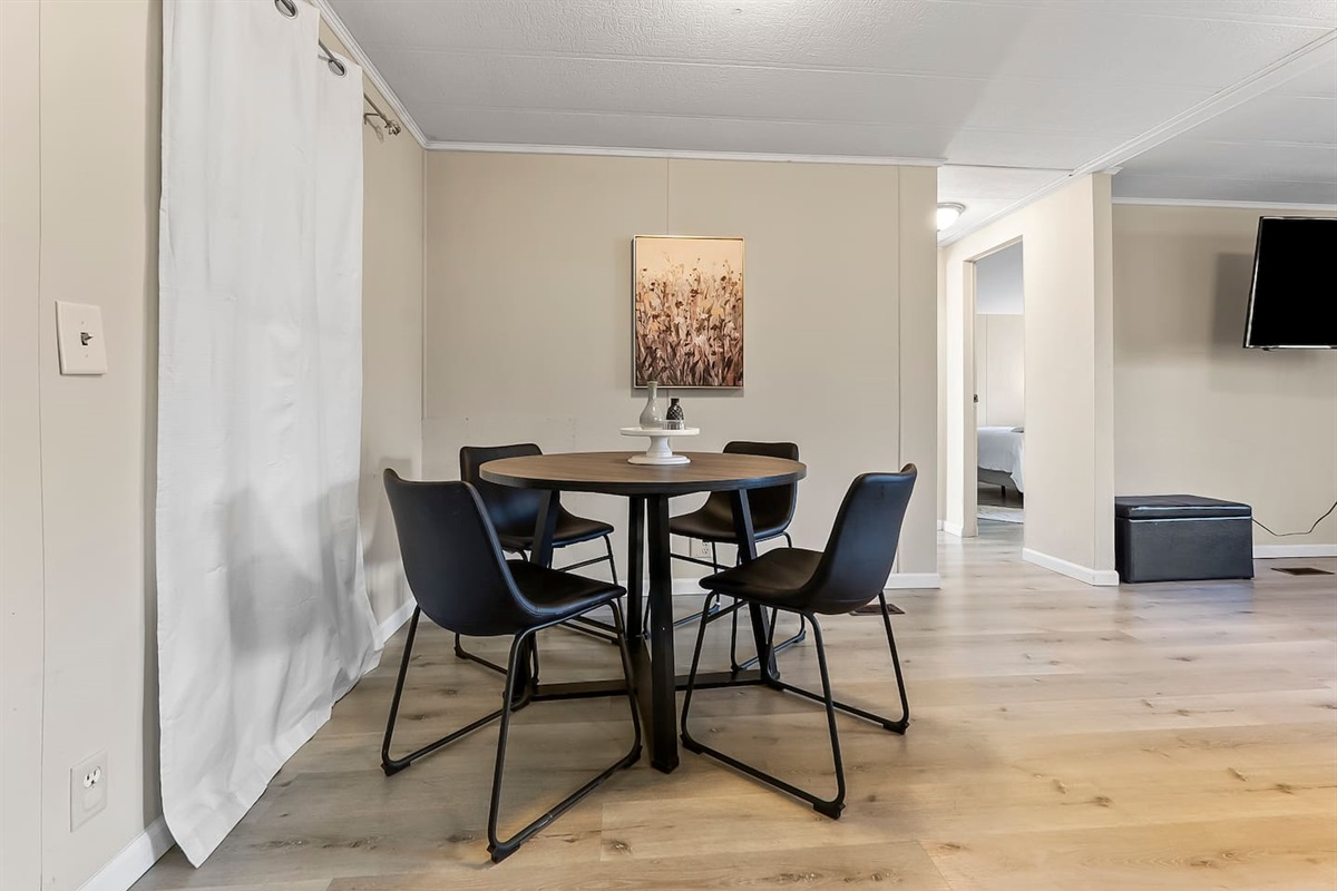 Cozy dining nook with seating for four, perfect for enjoying home-cooked meals or takeout.