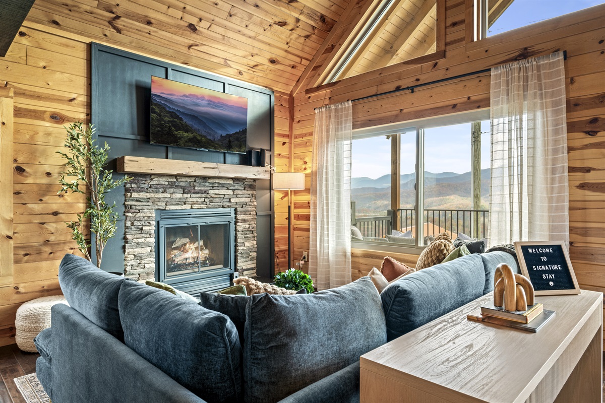 Unwind in the living room featuring a warm gas fireplace and a TV for cozy nights in the Smoky Mountains