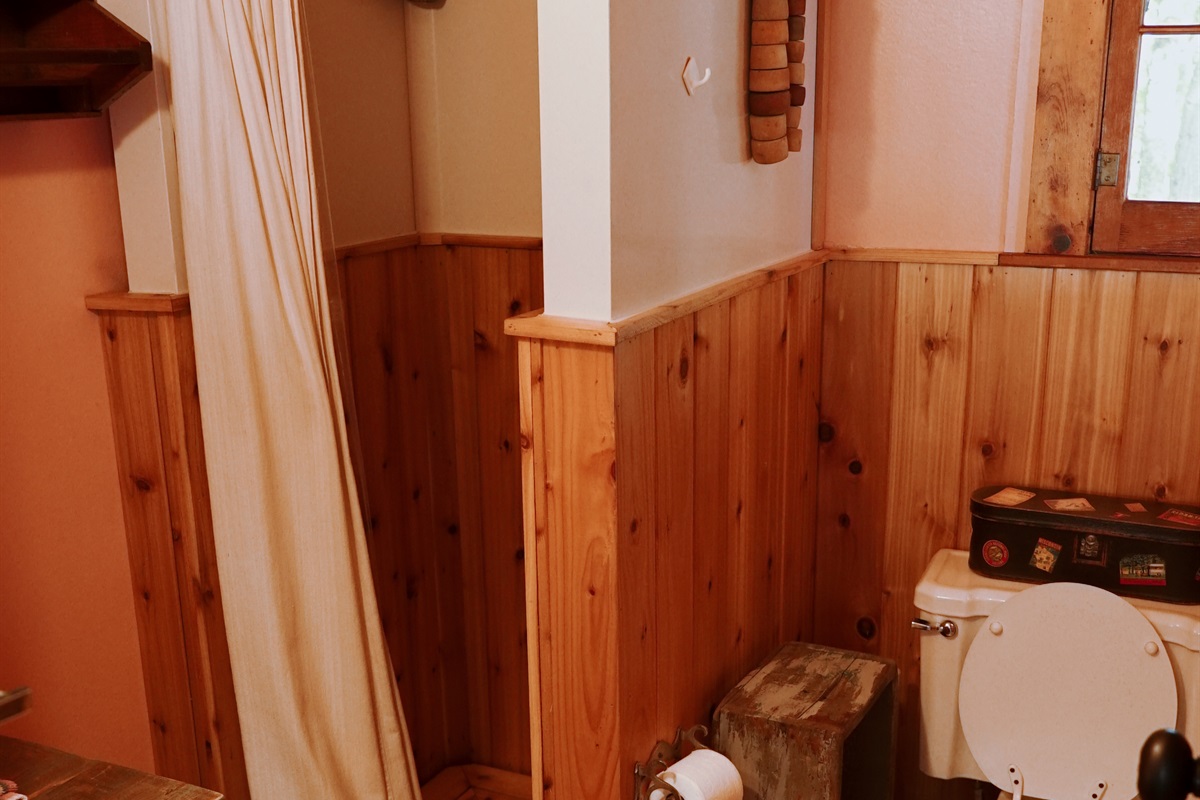 Full bathroom in cottage with shower.