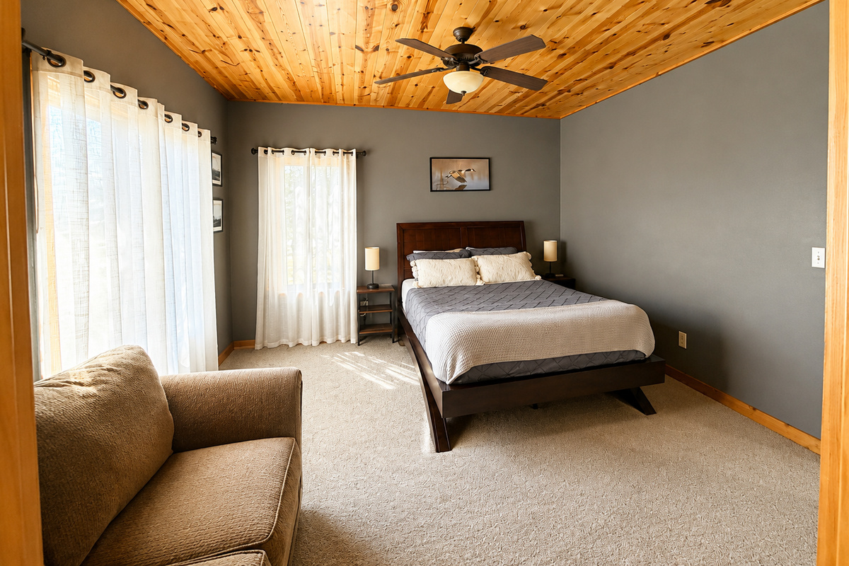 Spacious bedroom with a comfortable bed and sitting area gives guests extra room to relax and settle in.
