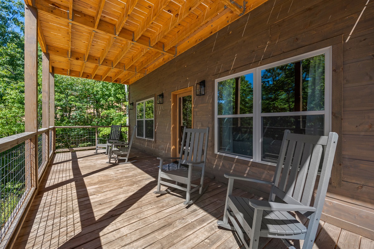 Rocking chairs on the lower level deck are perfect for taking in the view of the trees. 