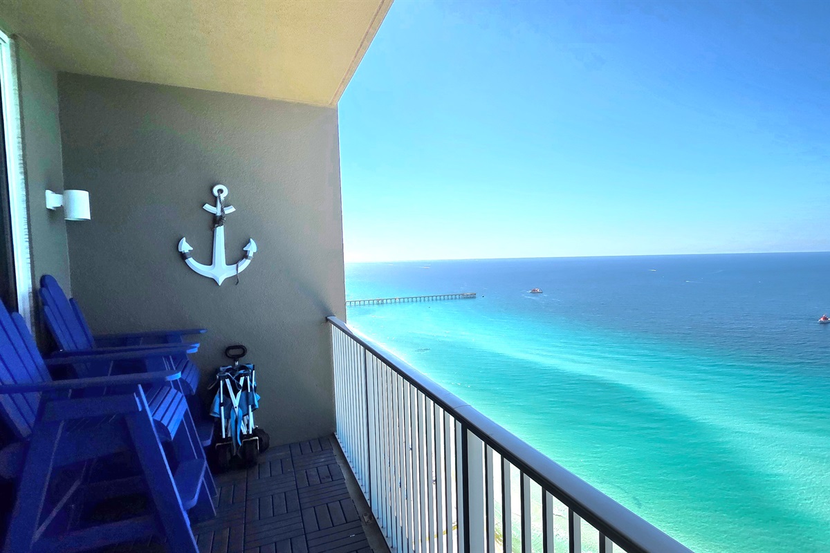 Balcony Bliss: Stunning ocean views from vibrant chairs—your front-row seat to paradise!
