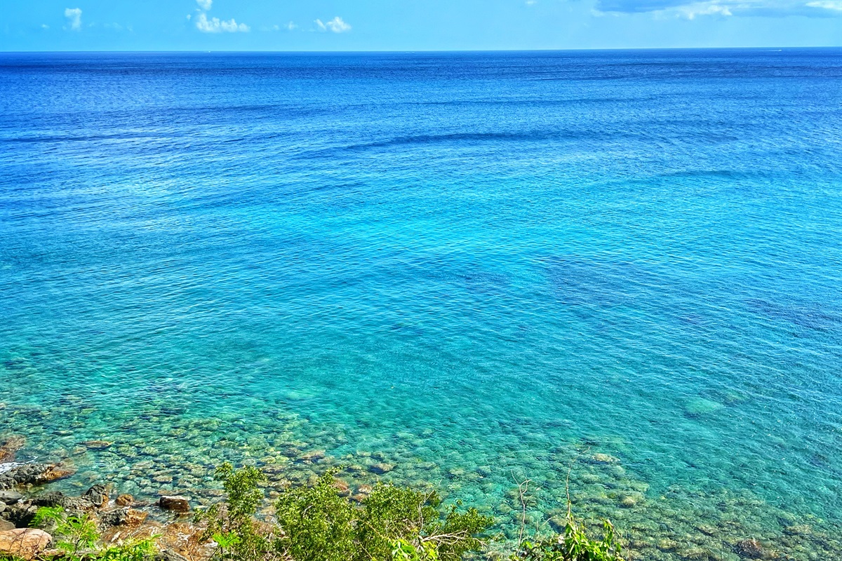 Glistening turquoise waters surround the pool area.
