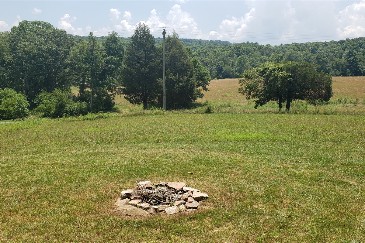 Firepit area with view of neighbor's prairie and pond. Stargazing blanket included!