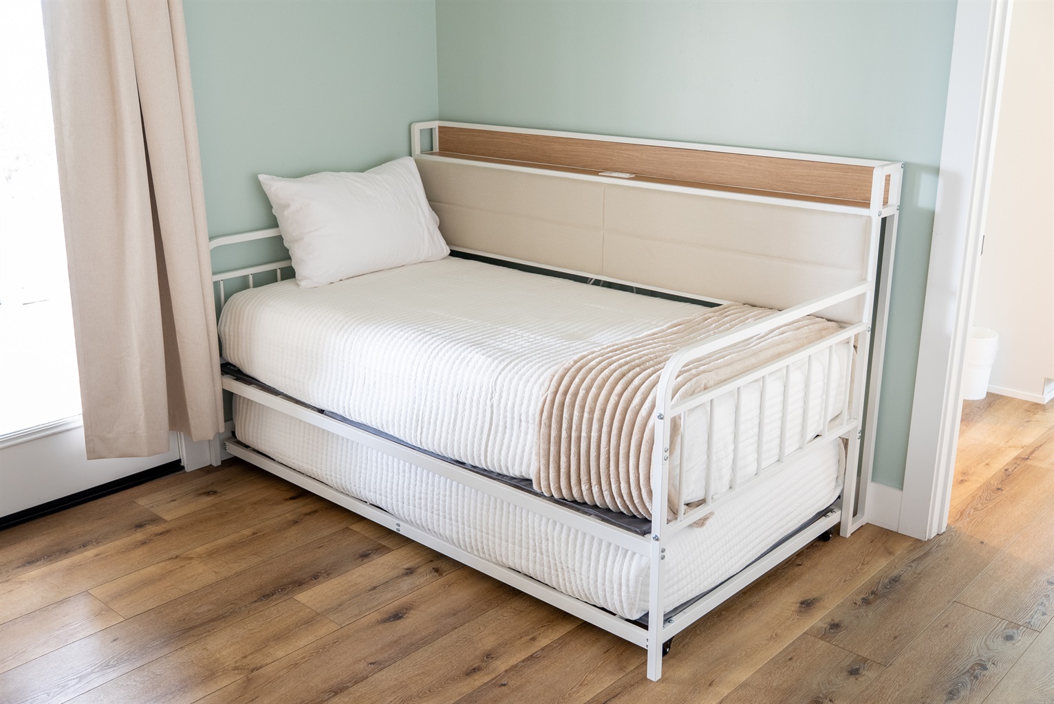 A flexible sleeping nook featuring a cozy trundle bed for extra guests.