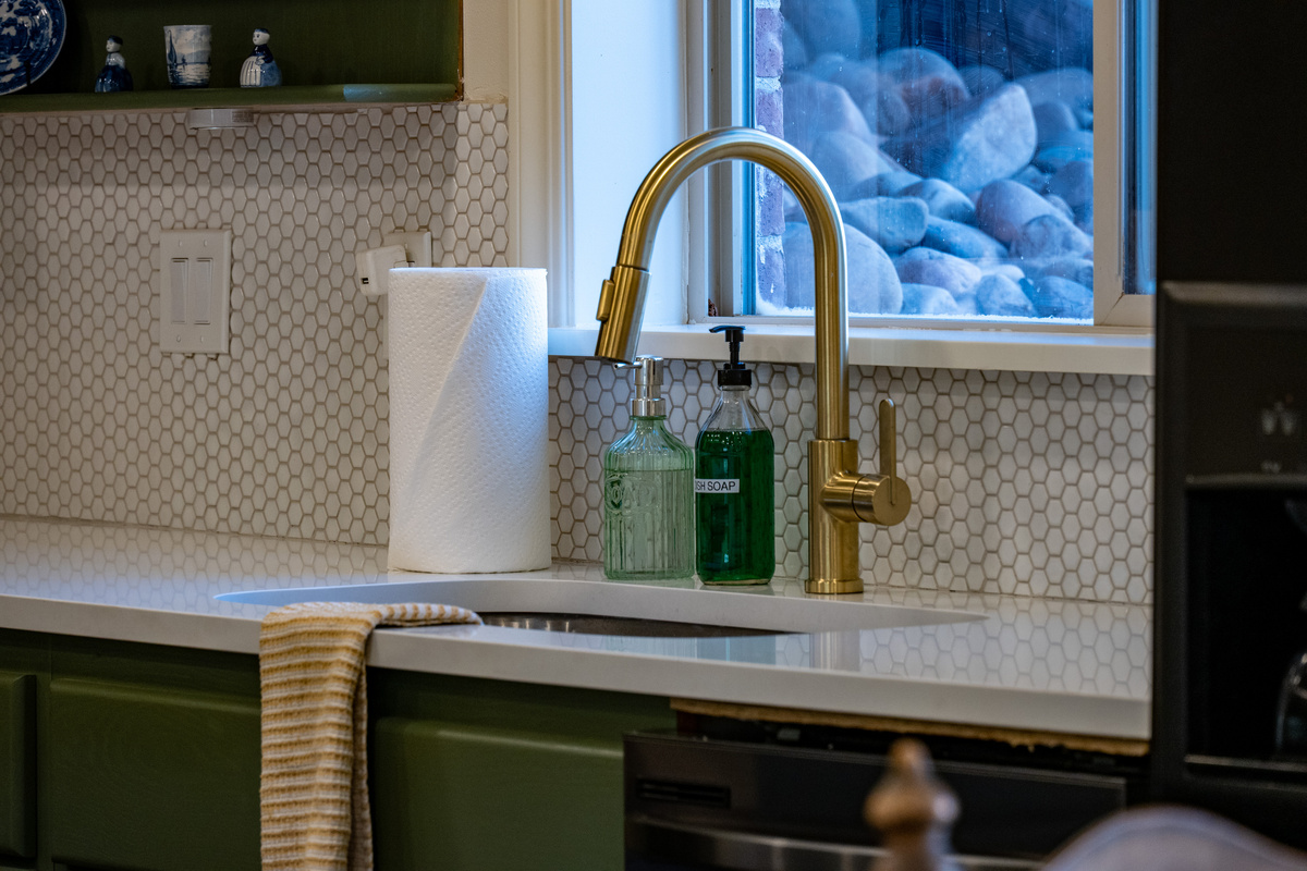Updated fixtures, a tile backsplash, and thoughtfully selected accents give the lower-level kitchen a distinctive, polished character.