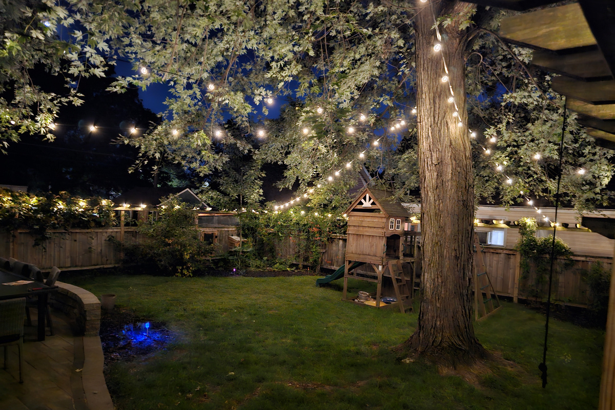 Enjoy the private fenced yard that is beautifully lit up at night.