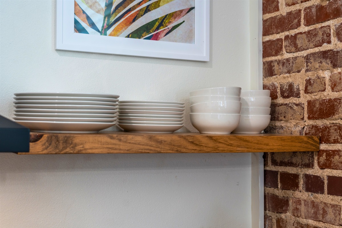 Open shelves neatly arranged with dishes and cups make it easy to enjoy meals during your stay.