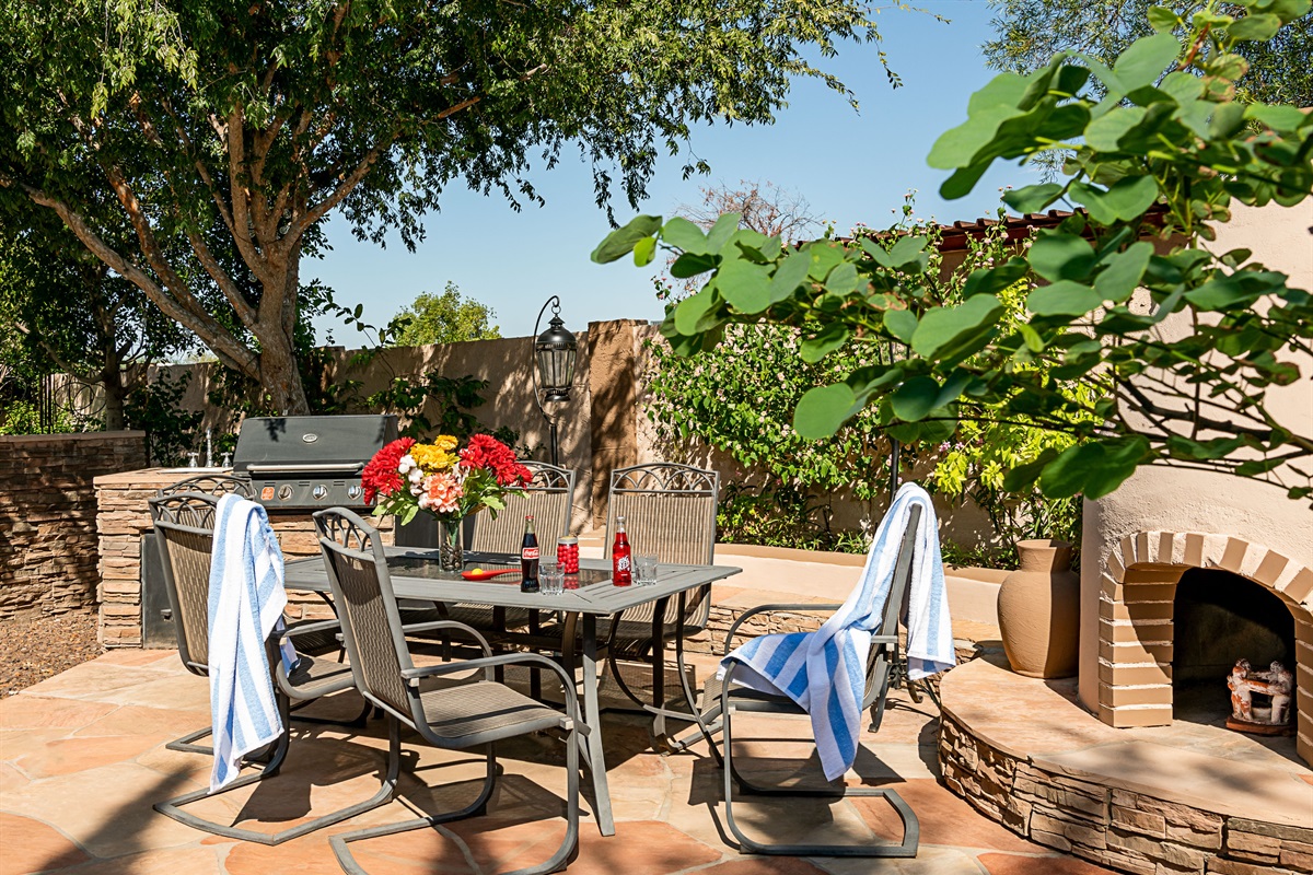 Enjoy alfresco meals in a vibrant garden setting, complete with a grill and shaded table perfect for post-swim gatherings or sunset dinners.