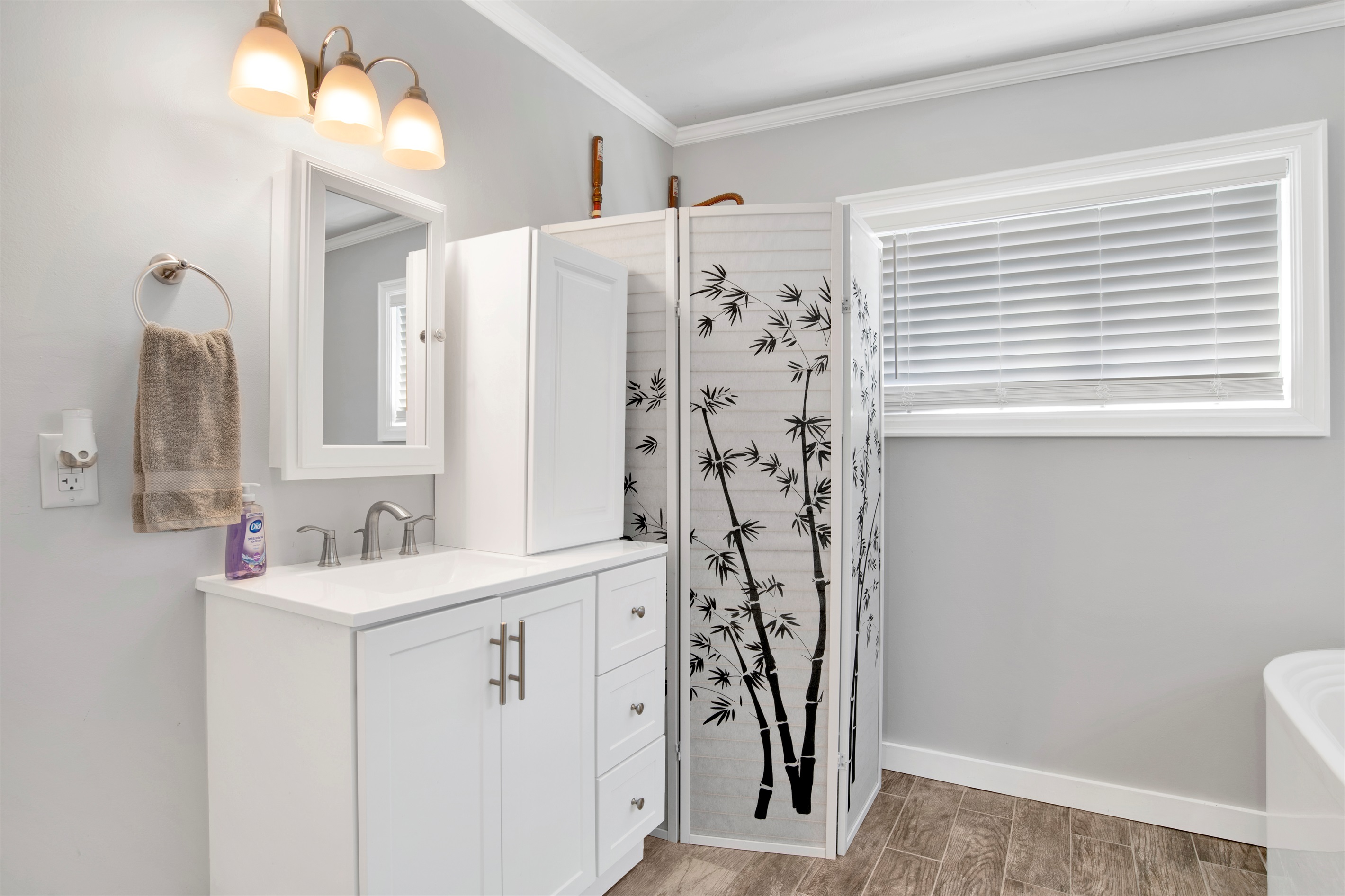 Spacious guest bathroom with towels provided.