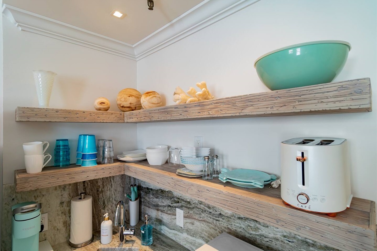 Custom hand made driftwood shelves show everything you need to have a wonderful breakfast, lunch or dinner in your Marisand suite. 