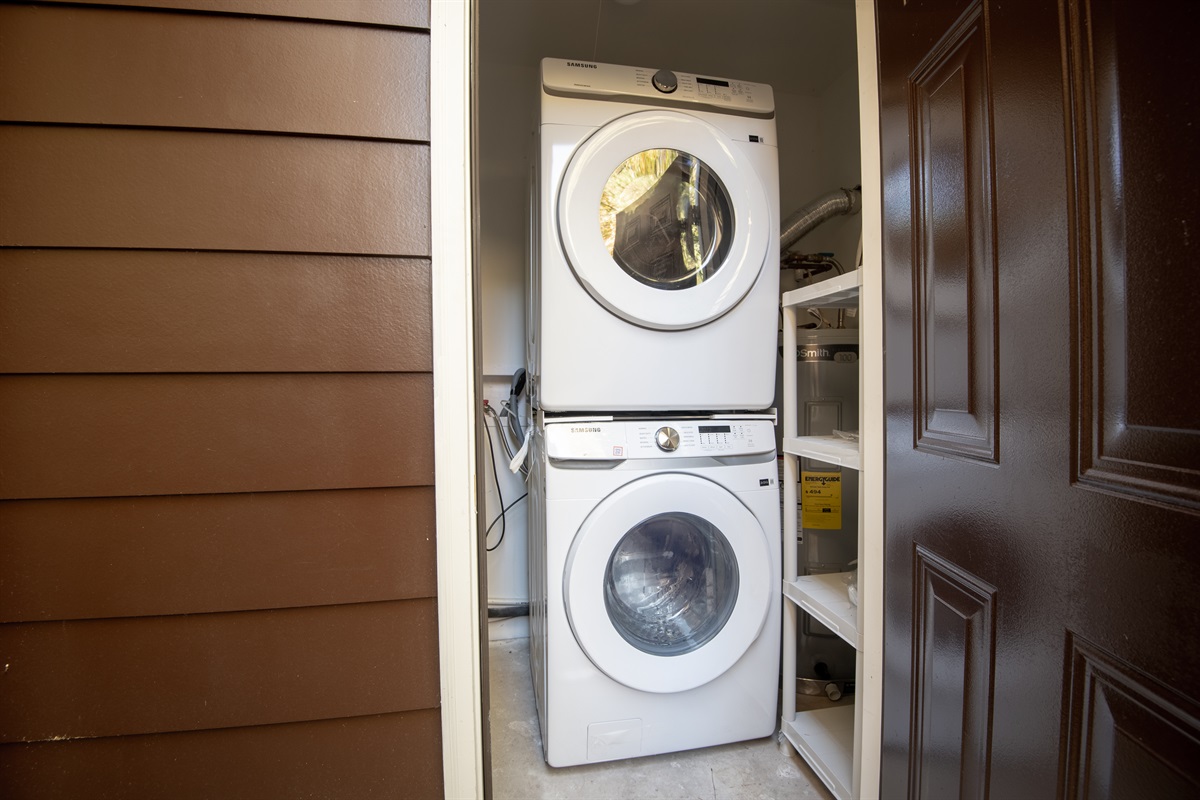The stackable washer and dryer are accessible through the patio.