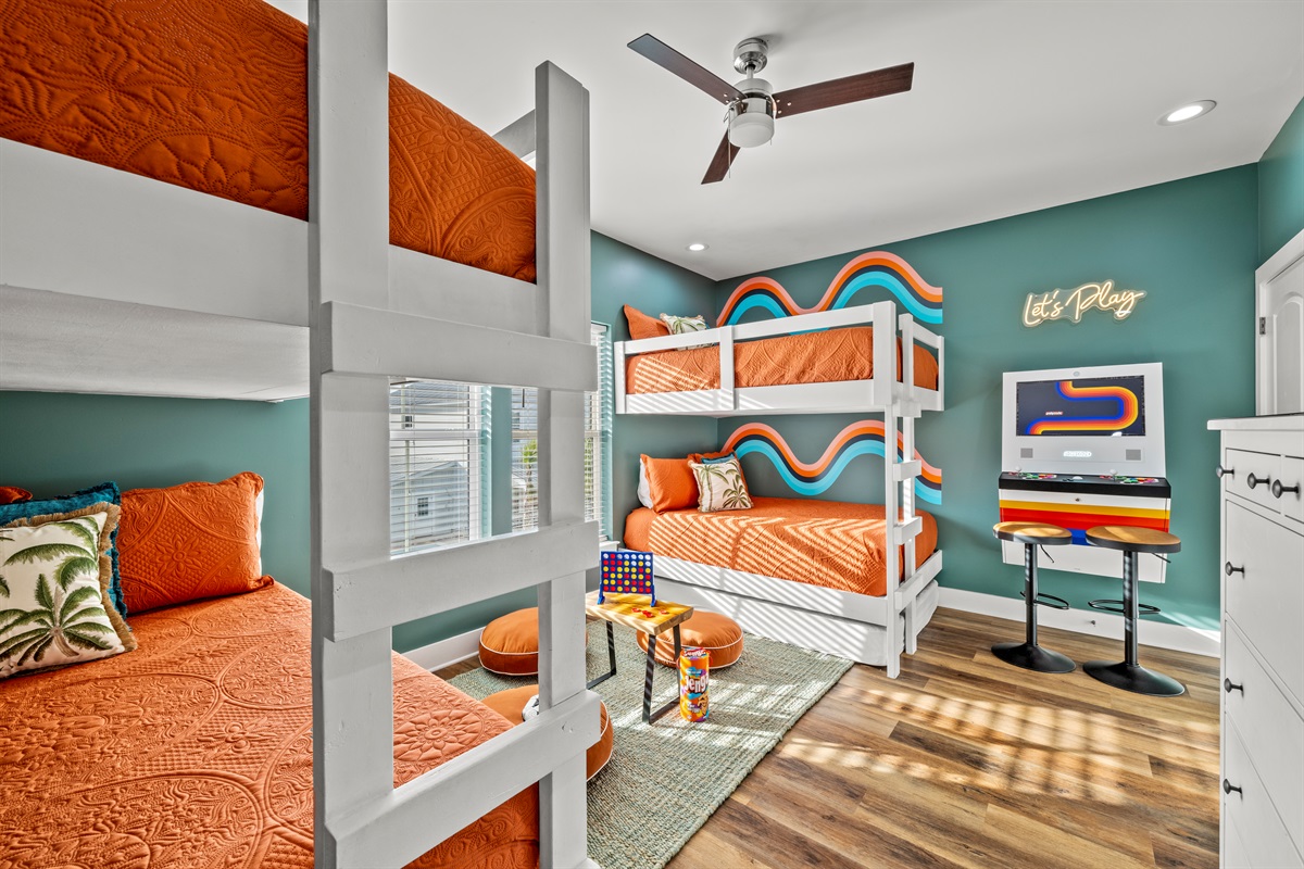 The ultimate kids room. Built in bunks, bright colors, and an arcade game make this space a vacation favorite for little guests.