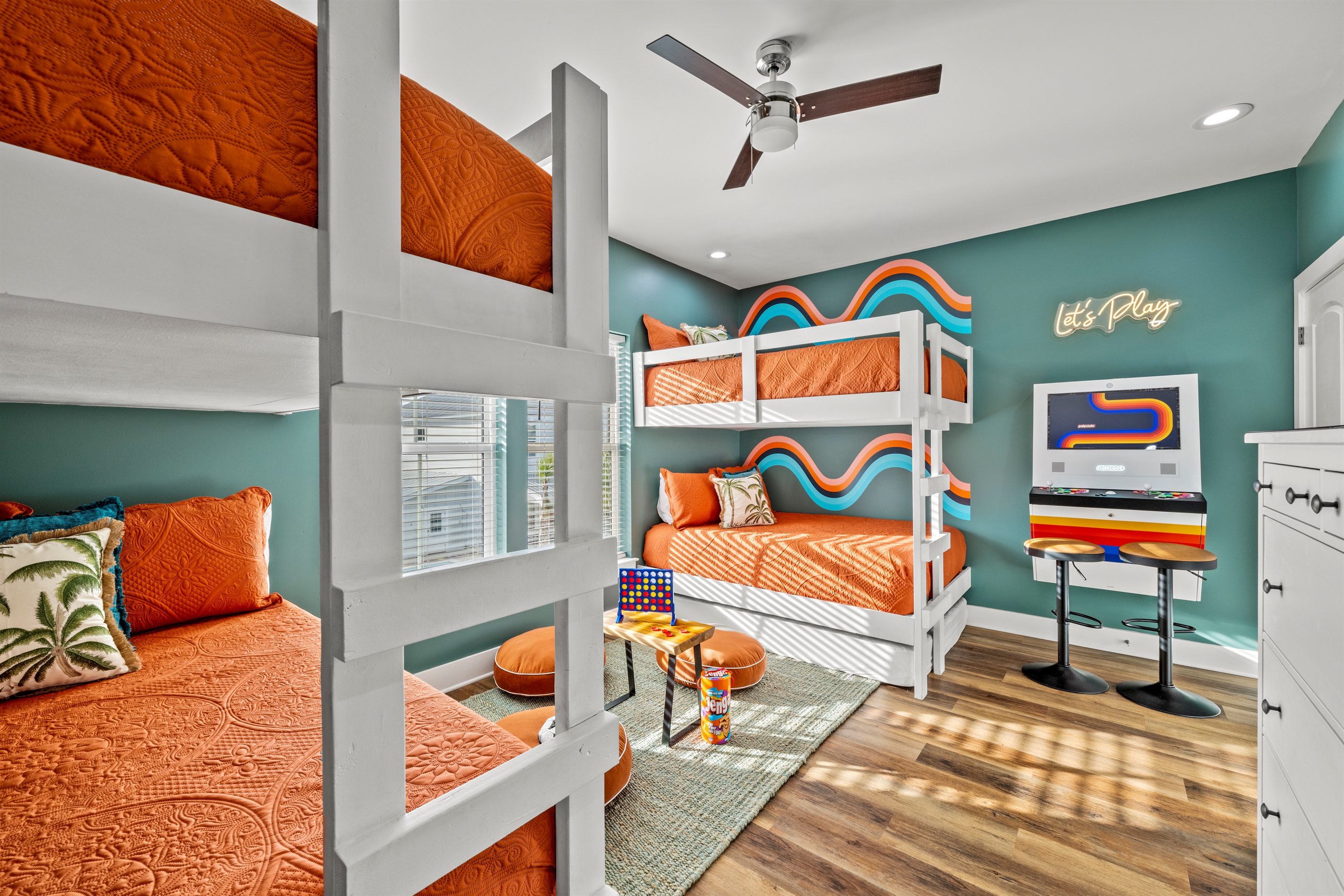The ultimate kids room. Built in bunks, bright colors, and an arcade game make this space a vacation favorite for little guests.