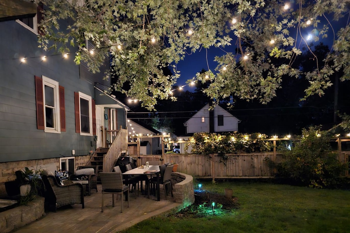 Private and spacious fenced yard is a lovely place to come together during the day and at night.