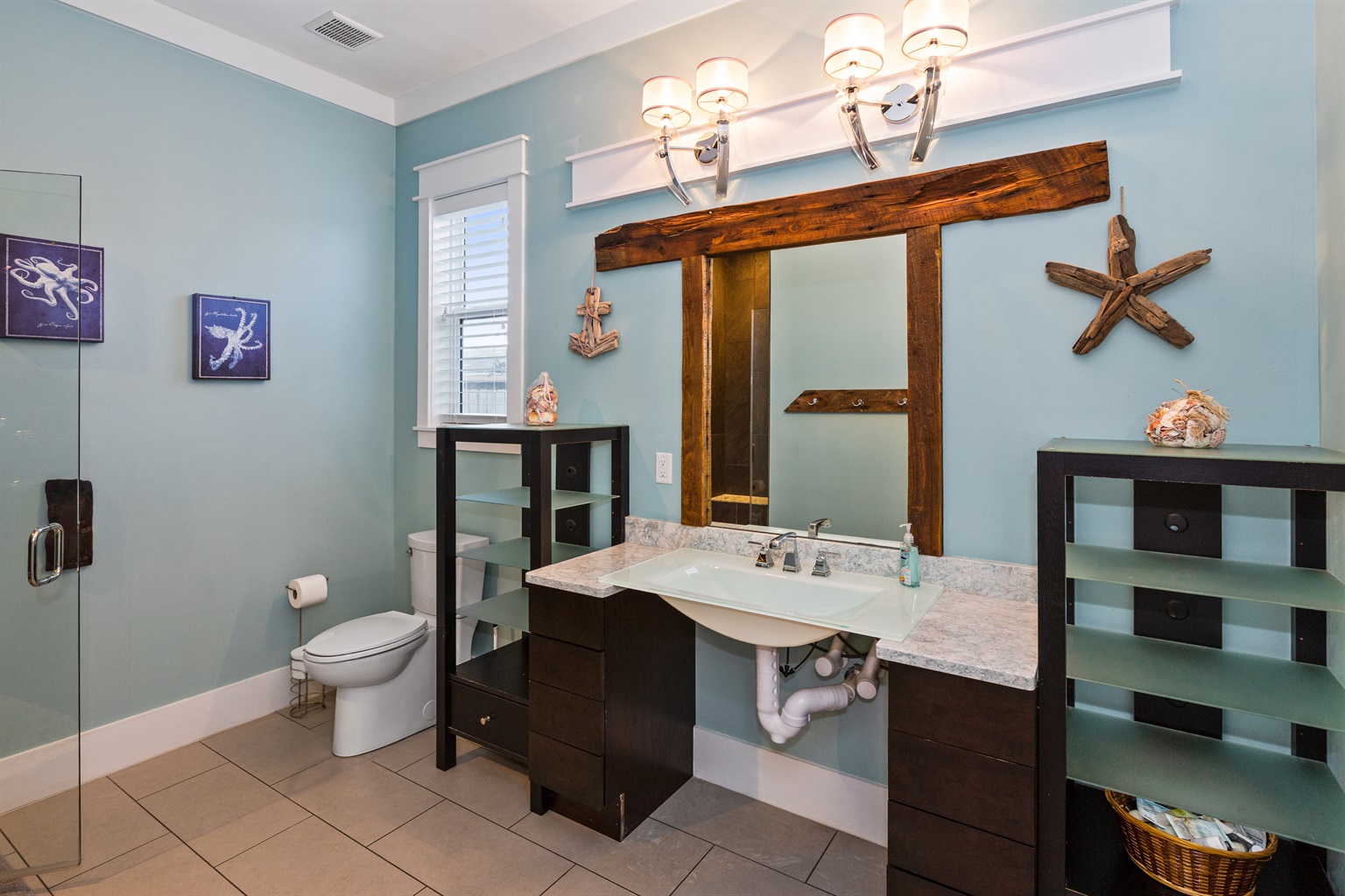 This wheelchair-accessible bathroom offers a roll under sink and roll in shower (with ramp upon request) for easy access to those who may have mobility challenges. It is a shared bath used by the first floor common area.