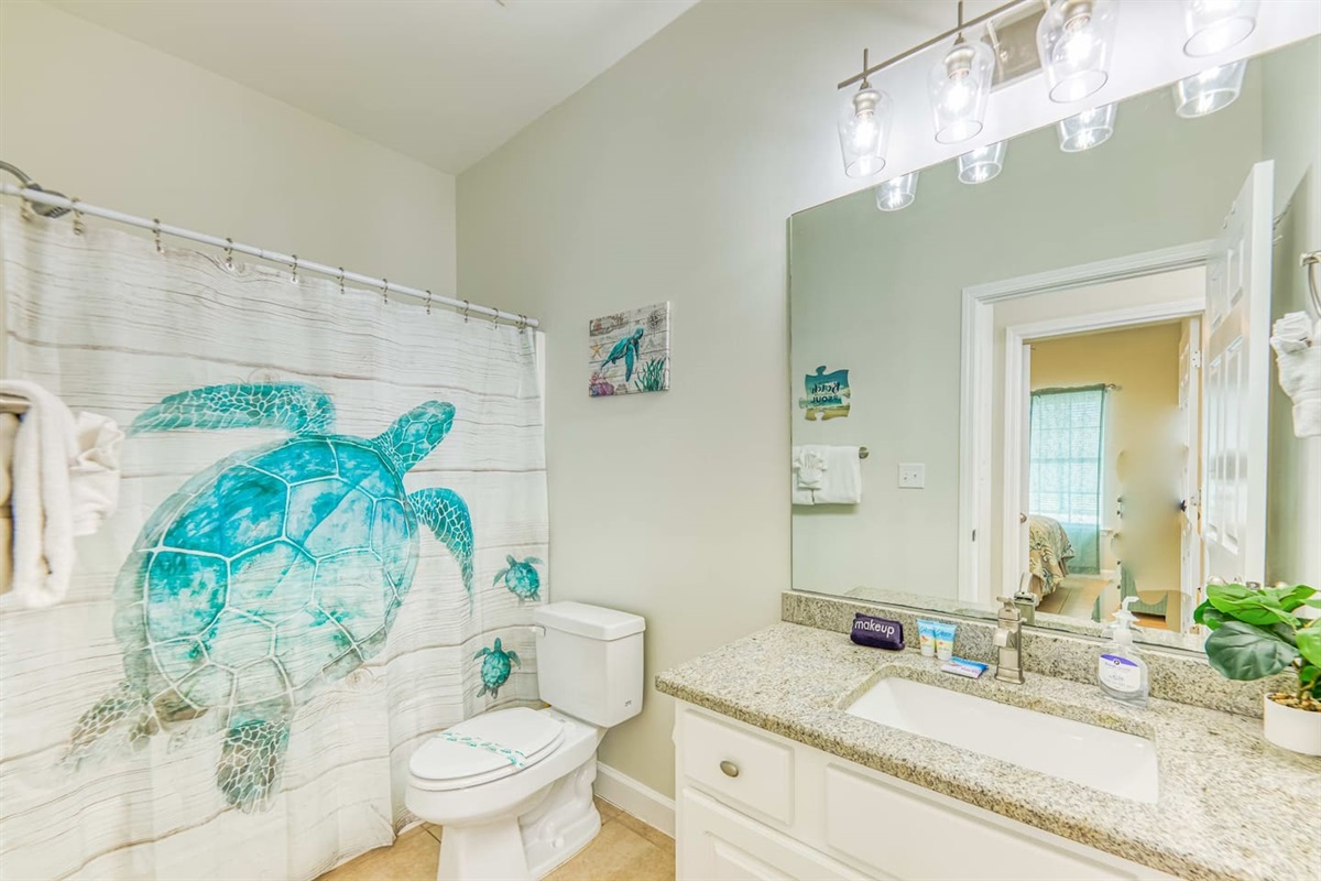 Bathroom Oasis: Refresh in this beach-themed retreat with turtle decor and modern fixtures!