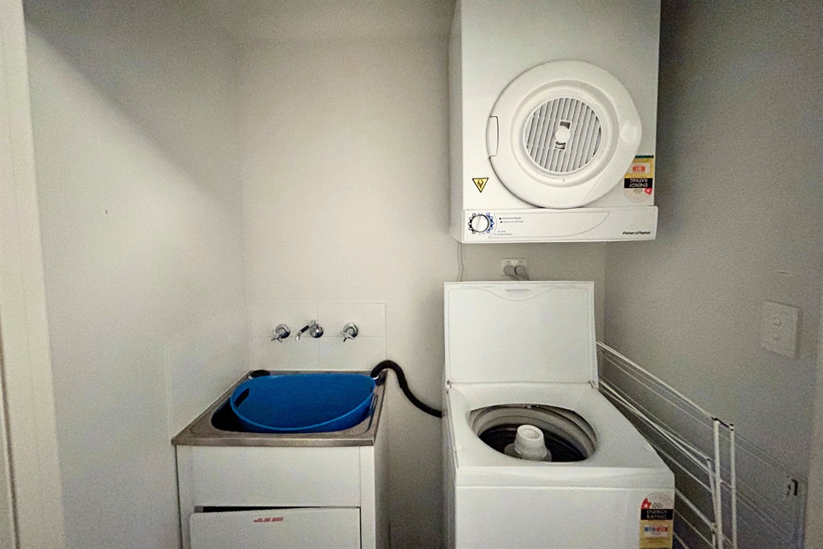 European laundry with top load washer & clothes dryer