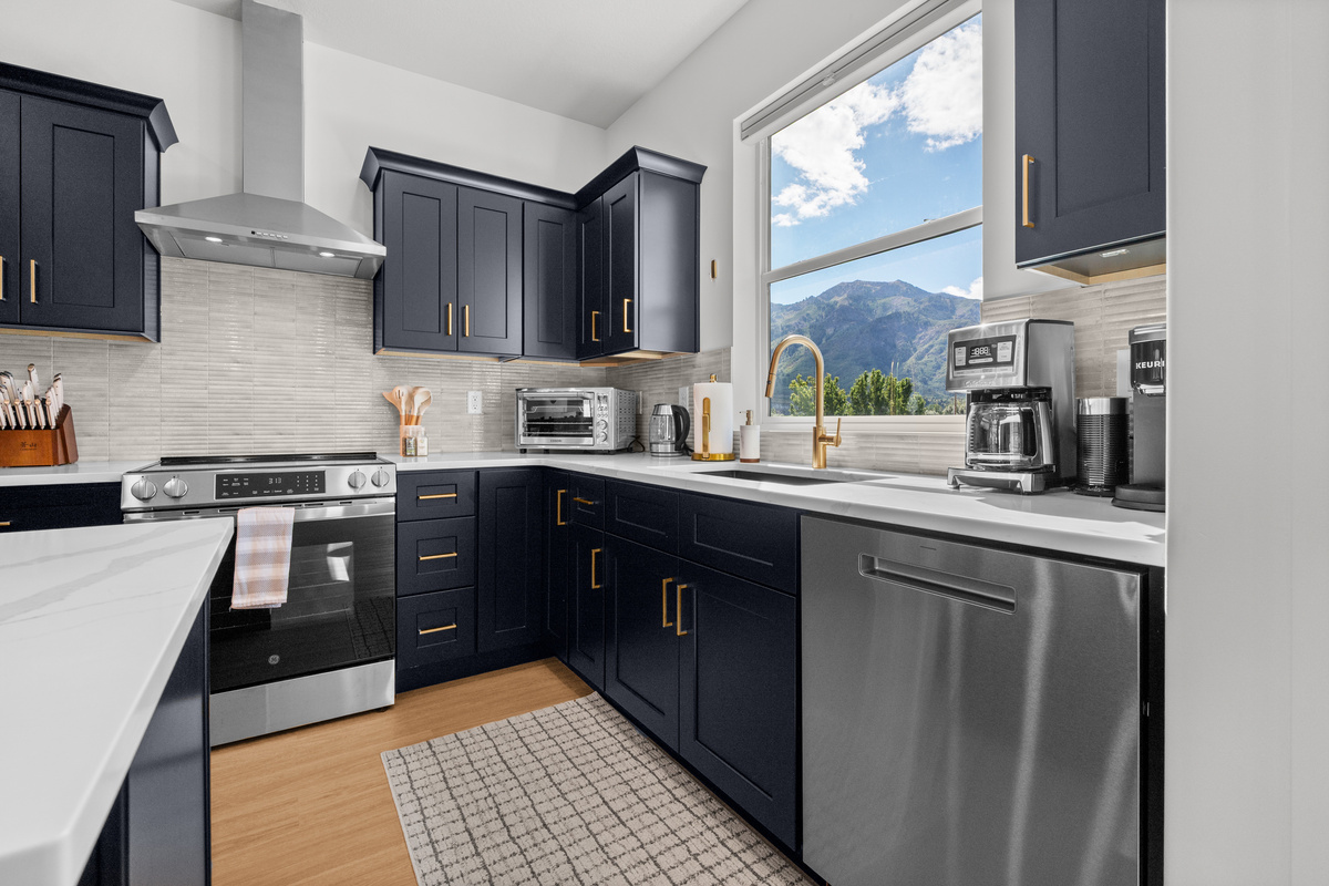 A modern, well-equipped kitchen with generous counter space makes everything from quick breakfasts to family dinners simple.