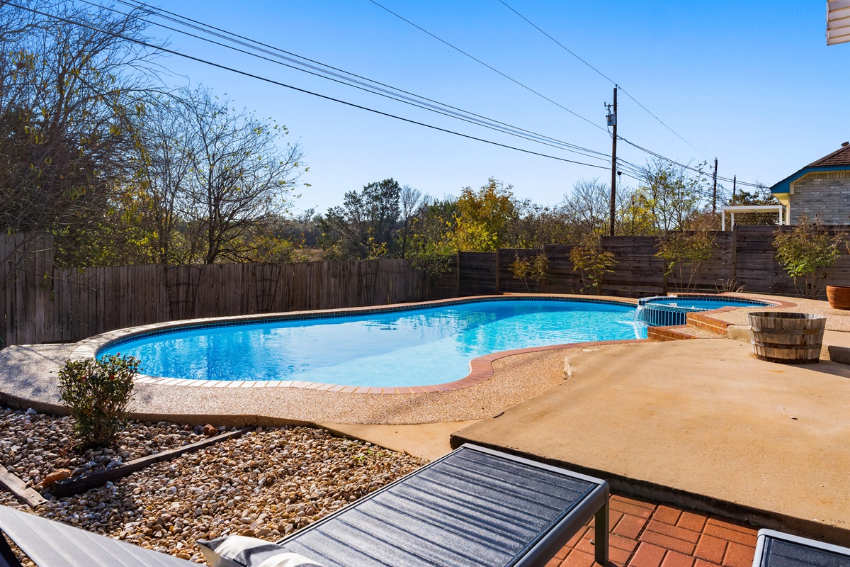 Enjoy the expansive sparkling pool and jacuzzi in the comfort of a private backyard.